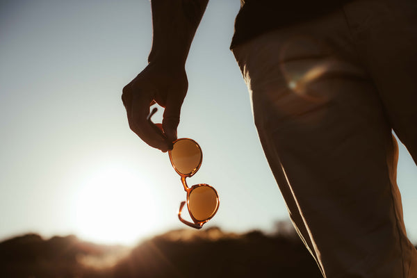 man holding otis sunglasses
